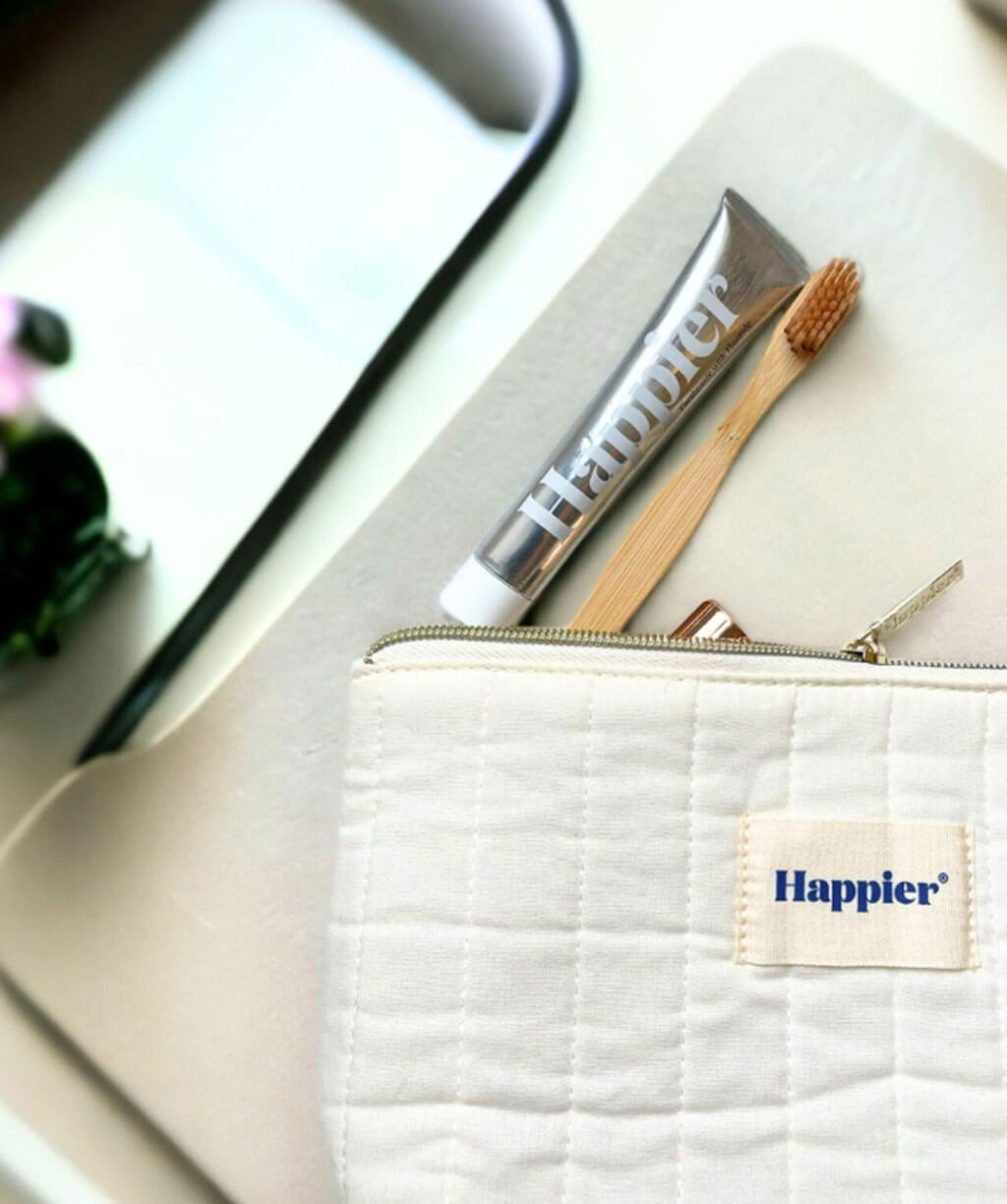 Washbag with toothbrush and toothpaste, including Happier Fresh Mint Toothpaste Travel Size 20ml.