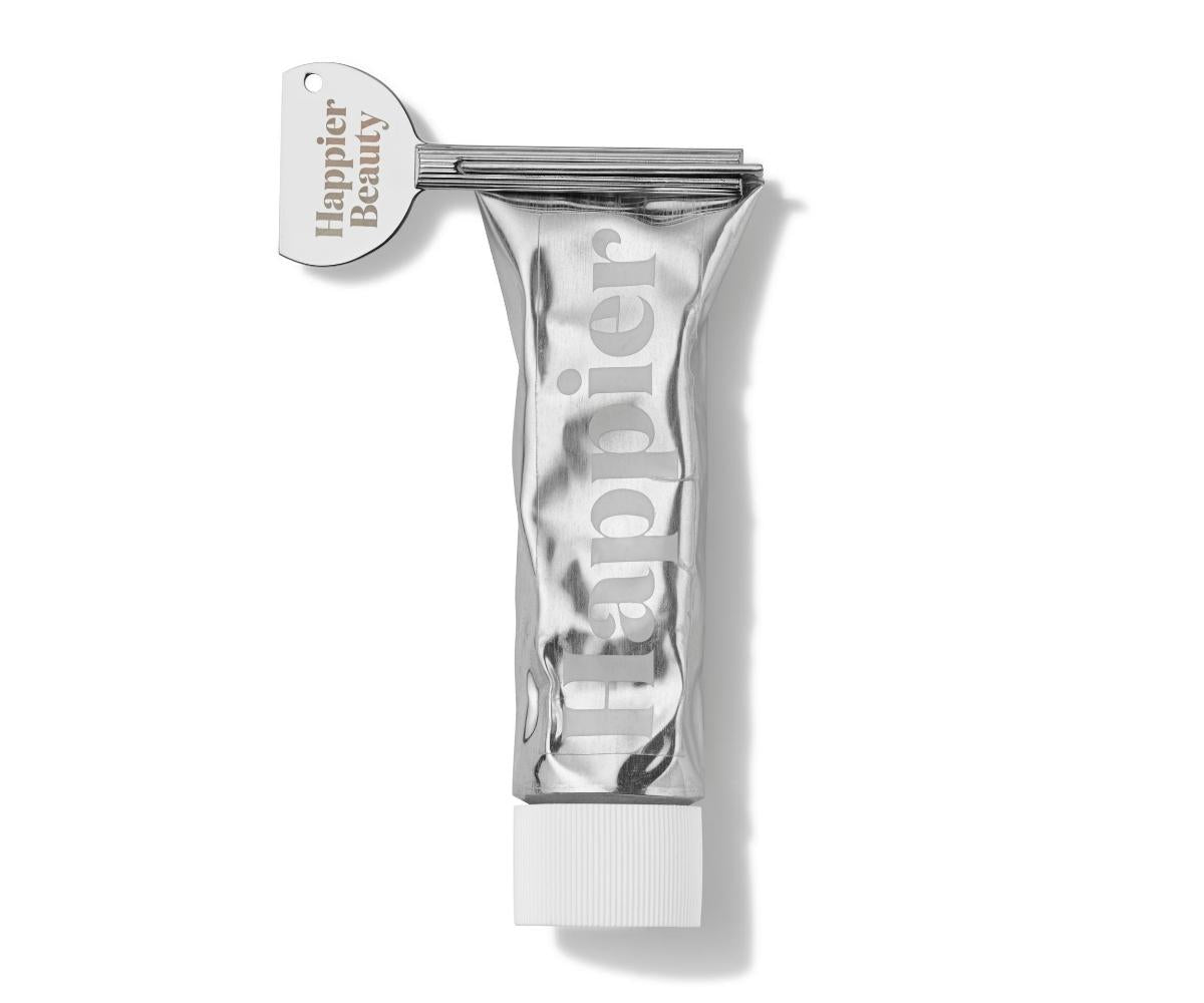 Happier Mint toothpaste tube on white surface.