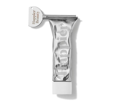 Happier Mint toothpaste tube on white surface.